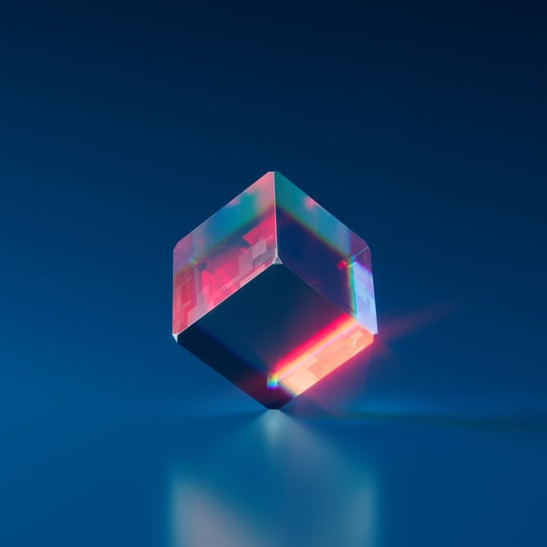 Translucid cube equlibred in one of the corners with red reflexions and dark-blue background
